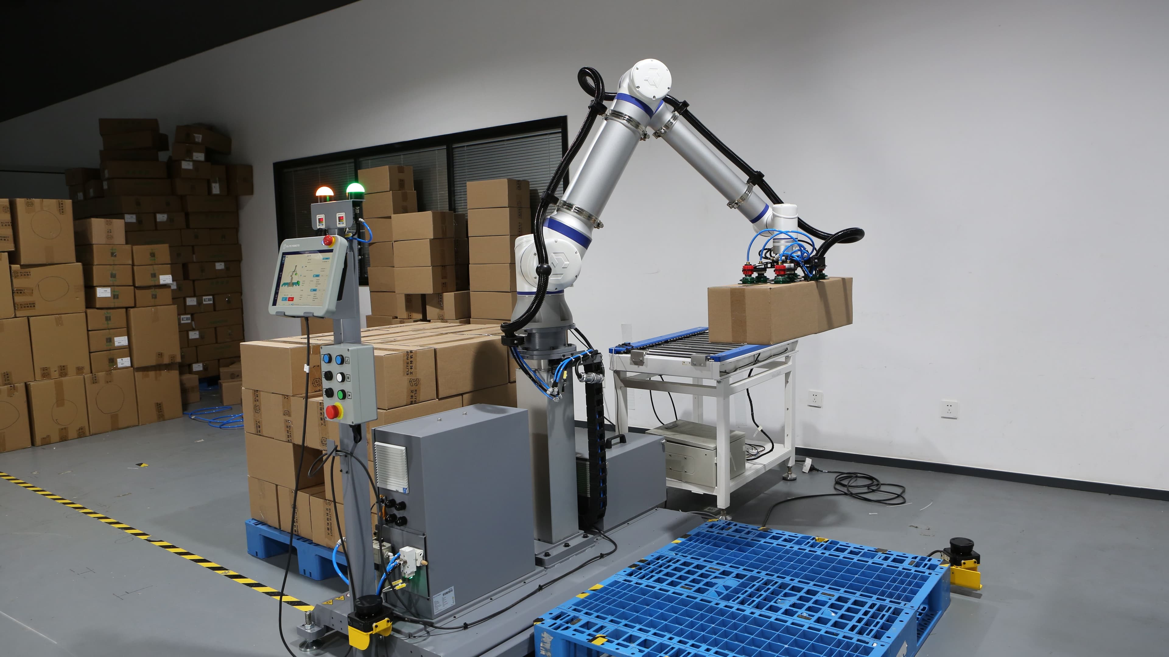 Collaborative robot performing palletising operation, stacking boxes on pallet