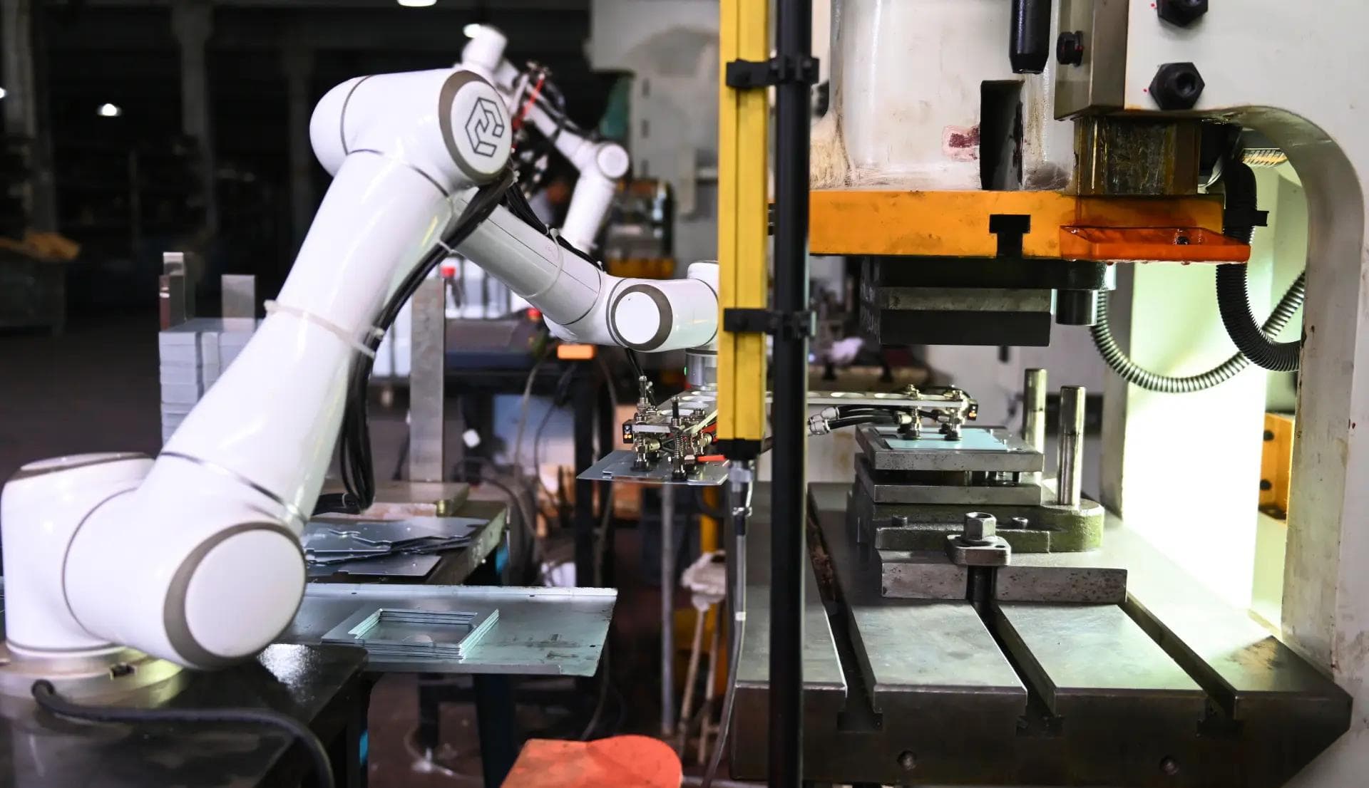 Collaborative robot arm performing pick and place operation on production line